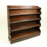 A Victorian mahogany waterfall front Bookcase, with scrolling moulded ends, and two long drawers