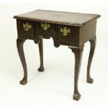 A walnut Lowboy, 18th Century and later, with an arrangement of three drawers on four cabriole