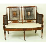 An Edwardian decorated satinwood Bergere Suite of Furniture, consisting of two seater Settee,