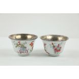 A pair of attractive early 19th Century Chinese white ground "Famille Rose" type Bowls, with blue
