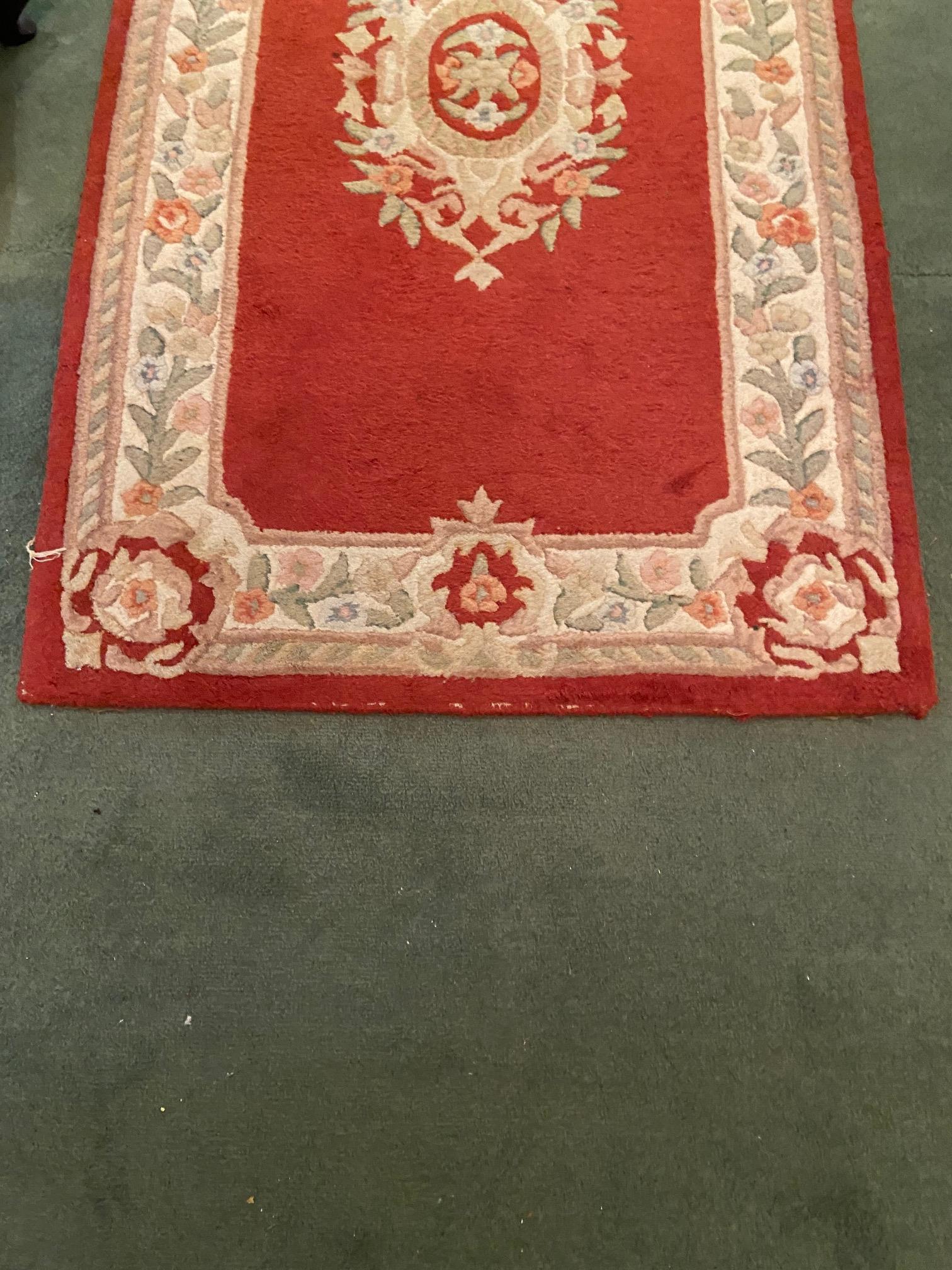 A set of three red/pink ground woollen Runners, each with a cream ground floral border and three - Image 2 of 8