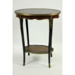 An elegant oval shaped two tier Table, the rosewood top with ormolu rim over a frieze with ornate