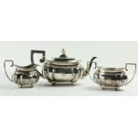 A three piece silver Tea Service, Chester c. 1900, comprising ogee shaped teapot with gadroon edge