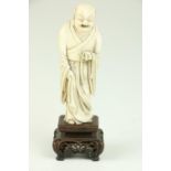 A 19th  Century Chinese carved ivory Figure, of a monk in long robes and holding beads, on stand,