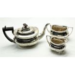 A silver two handled half reeded Sugar Bowl, with gadroon edge on four ball feet, Sheffield 1897,