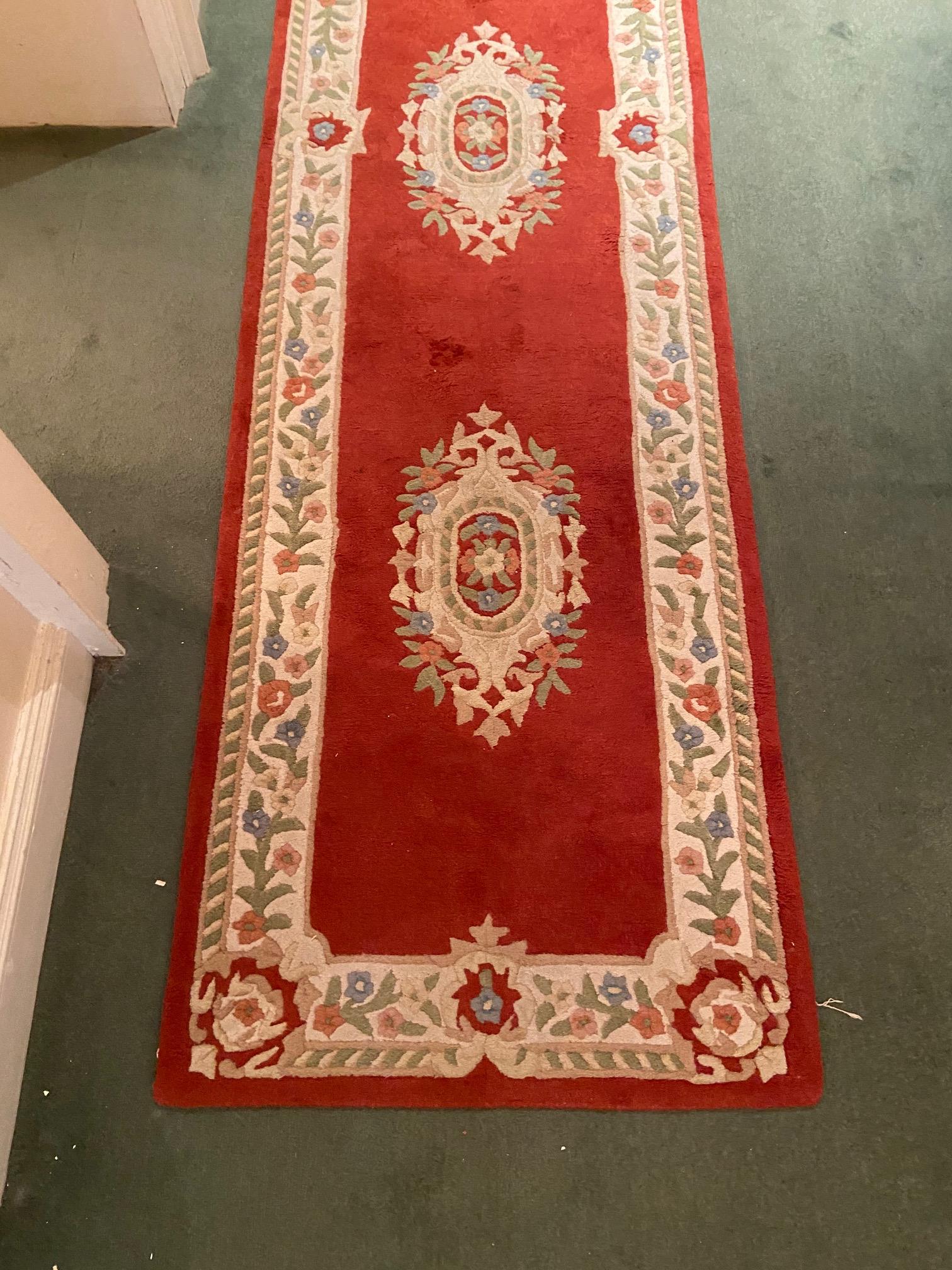 A set of three red/pink ground woollen Runners, each with a cream ground floral border and three - Image 4 of 8