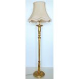 A giltwood Lamp Standard, on circular base with salmon coloured frill shade. (1)