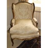 A good quality 19th Century wing back gilt Armchair, with padded back and cushion seat, raised on