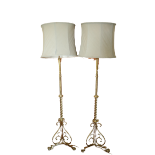 A good pair of Edwardian brass Standard Lamps, each on tripod base with three lion paw feet, with