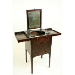 A George III inlaid mahogany Gentleman's Washstand, the divided top opening to reveal a pull up