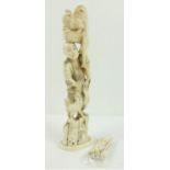 A Chinese carved Figure of a Man and a cockerel on his head and at his feet (arm missing) 32cms