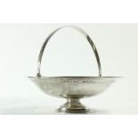 A pierced silver Cake Basket, with swing handle on circular stem base, Birmingham 1936, 10" (