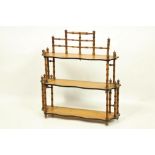 A Victorian three tier satin birch Wall Bracket, with serpentine shaped shelves and simulated bamboo