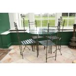 A modern heavy wrought iron Patio Suite, consisting of circular table with glass top, set of 4