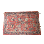 A 19th Century Persian claret ground woollen Carpet, with large floral centre panel and narrow