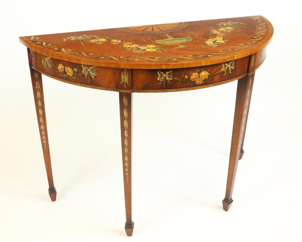 A George III mahogany demi-lune Side Table, profusely decorated with a centre urn issuing garlands