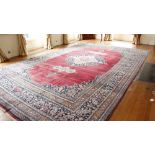 A fine semi-antique burgundy ground Persian Carpet, the large centre medallion with stylized