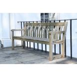 A pair of slatted wooden Garden Benches, with carved back rails, and straight slatted seats,