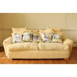 A large modern three piece Suite of Seat Furniture, with varied cushions covered in lemon fabric,