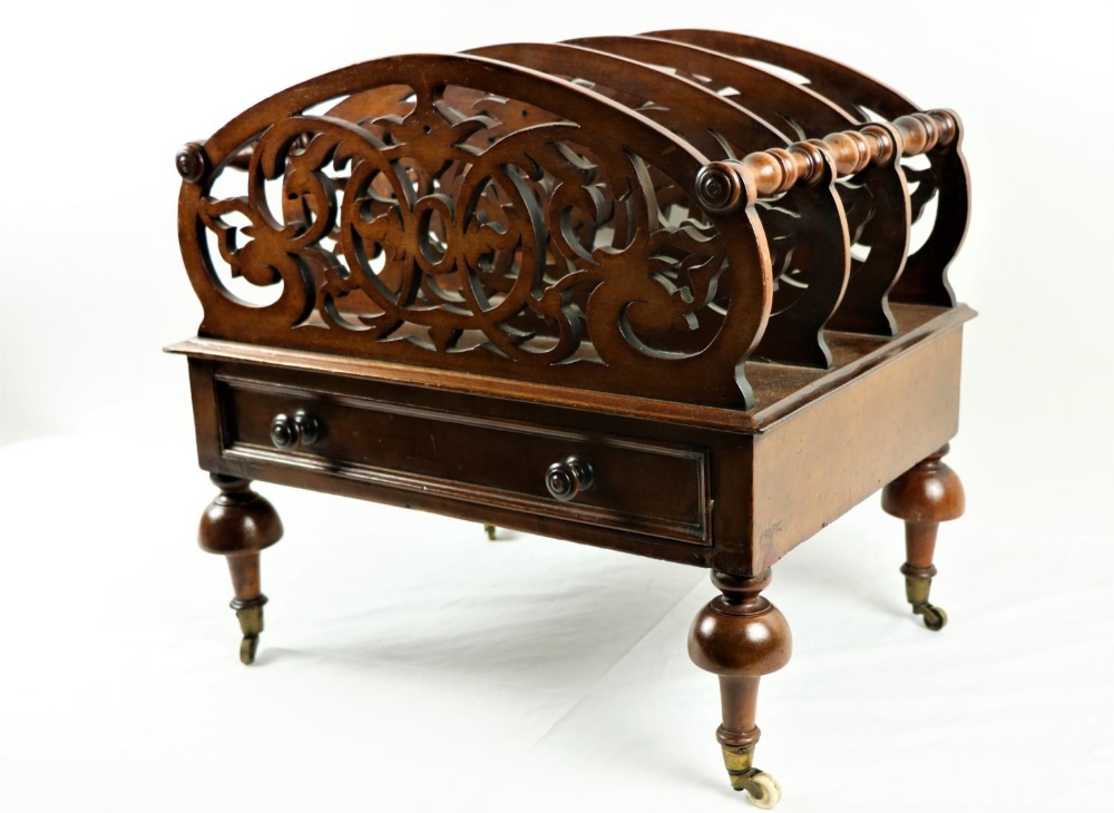 A Victorian walnut Canterbury, with pierced and arched dividing panels united by turned rails