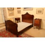 A French 4' walnut Bedstead, the panelled headboard with a leaf crest and conforming footboard,