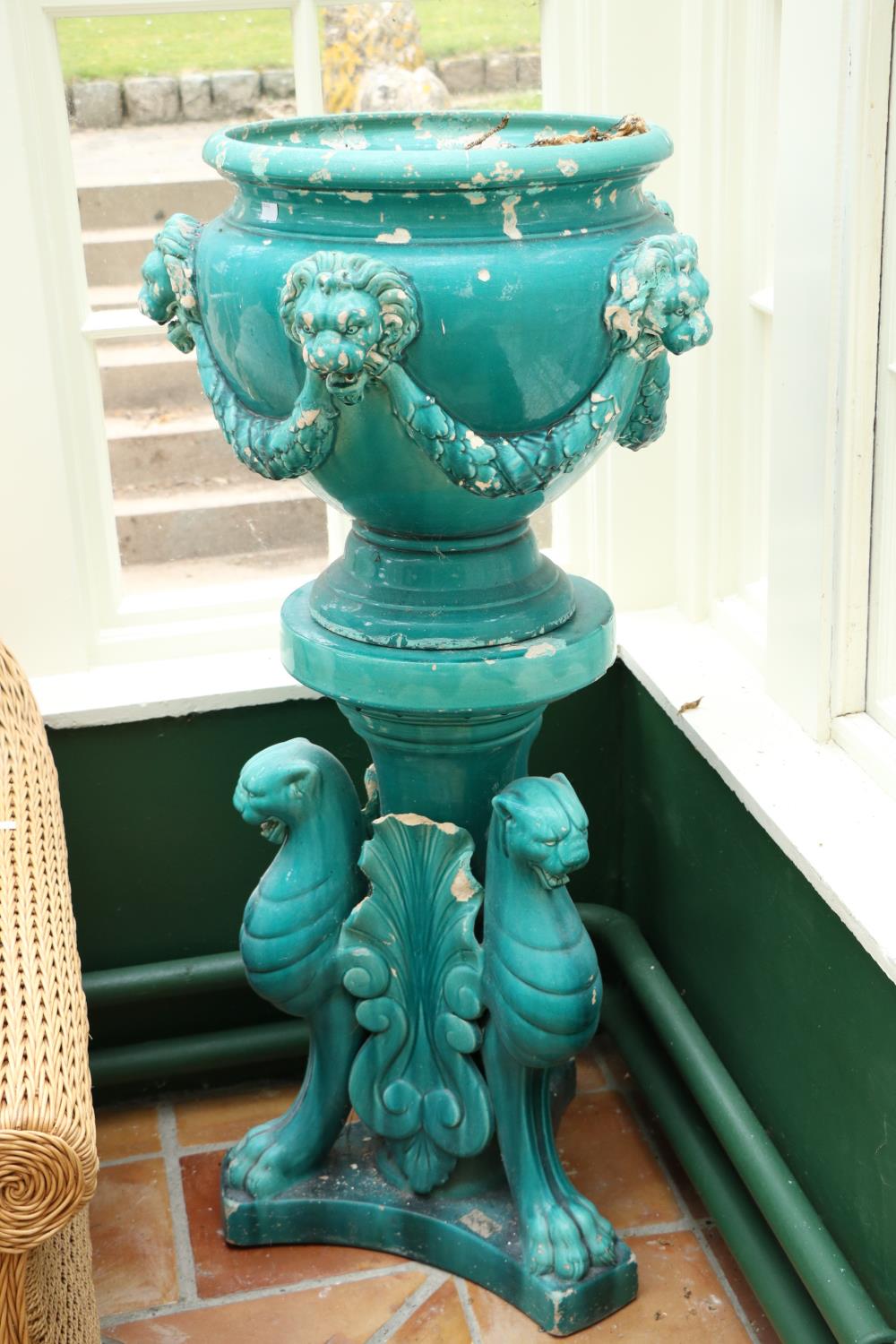 A pair of very large turquoise coloured glazed porcelain matching Urns and Stands, the urns with