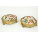 A pair of 19th Century circular gilt Footstools, each with scrolling foliage on three scroll legs,