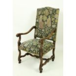 A 17th Century style carved and moulded walnut Armchair, with shaped stretchers, upholstered with
