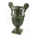 A bronze Grecian Vase, with classical figures in relief, each handle with two grotesque masks on a