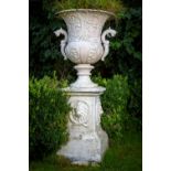 A large heavy set of 4 unusual cast iron Garden Urns, each relief cast with vases of flowers and two