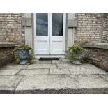 A pair of good quality two handled lead Garden Urns, each with two cherubs, flanking an urn with