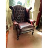 A button back leather Wing Armchair, with loose cushion seat on front cabriole legs. (1)