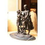 A bronze Group, modelled with two girls with basket of fruit on oval limestone base, 17 1/2'' (