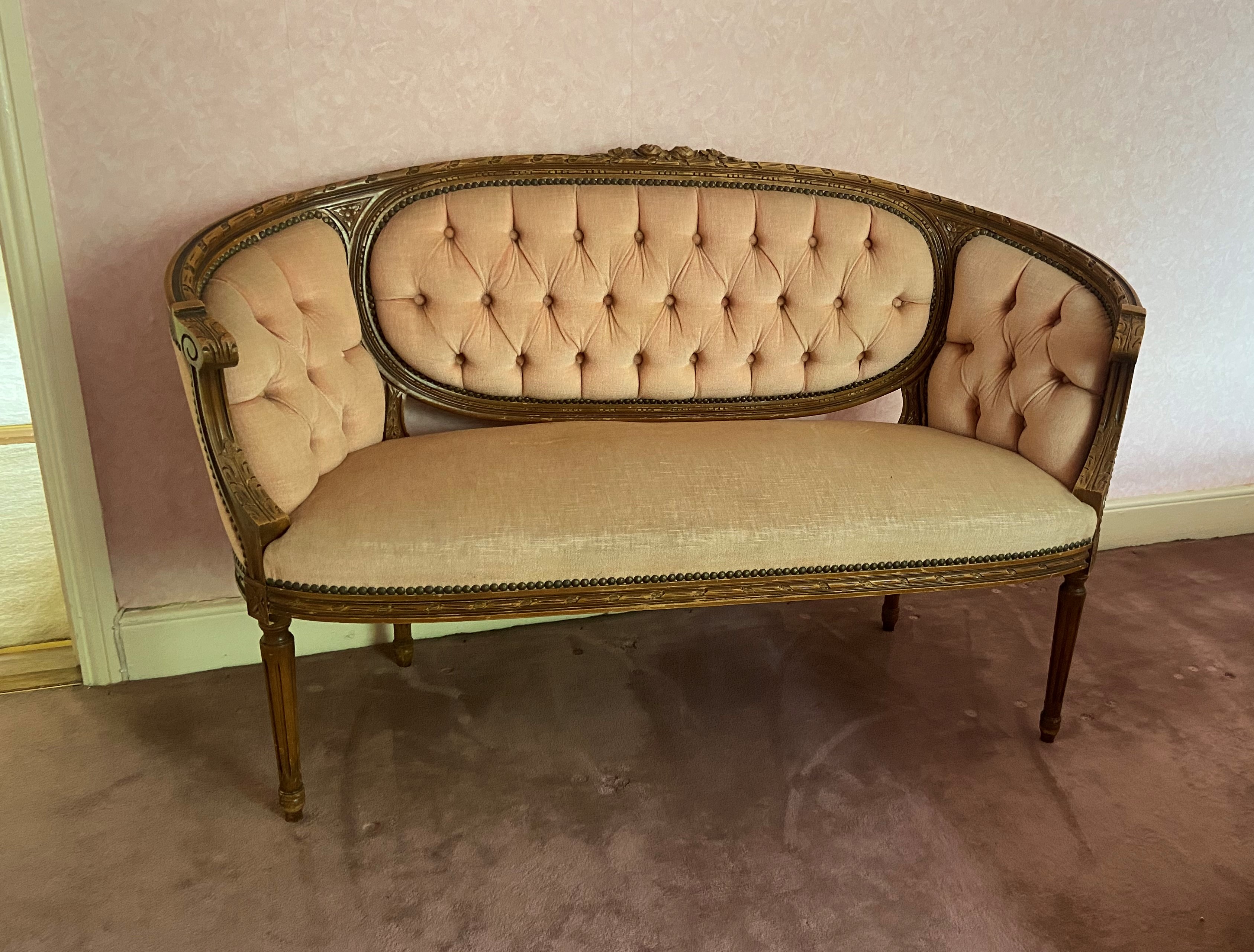 A French carved beech kidney shaped Settee, with triple panel back and ribbon moulded frame and