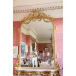 An extremely attractive 19th Century gilt Console or Overmantel Mirror, crested with a circular leaf