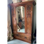 An Edwardian walnut Wardrobe, with mirror door and base drawers, 77'' x 48'' (195cms x 122cms); a