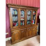 A Victorian style mahogany Library Bookcase, with moulded pediment above four arched and glazed