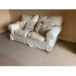A two seater Easy Settee, covered in ivory fabric and loose cushions, 68'' (172cms). (1)