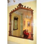 A carved oak Gothic Revival Overmantel, with arched top and anthemion crest and Gothic scrolls and