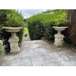 A pair of heavy cast iron Garden Urns, each with a tongue and dart moulded folded rim on a half