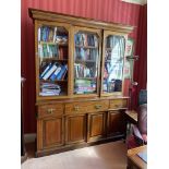 An inlaid mahogany three door Library Bookcase, with moulded cornice above three glazed doors, three