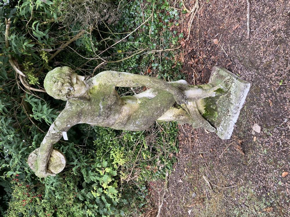 A nicely weathered composition Figure, of naked disc thrower by a tree stump on rectangular base,