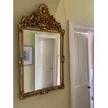 An attractive gilt Wall Mirror, in the 18th Century style, with ornate pediment with shell crest,