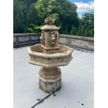 A very attractive composition stone Garden Fountain, with basket of fruit finial above four lion