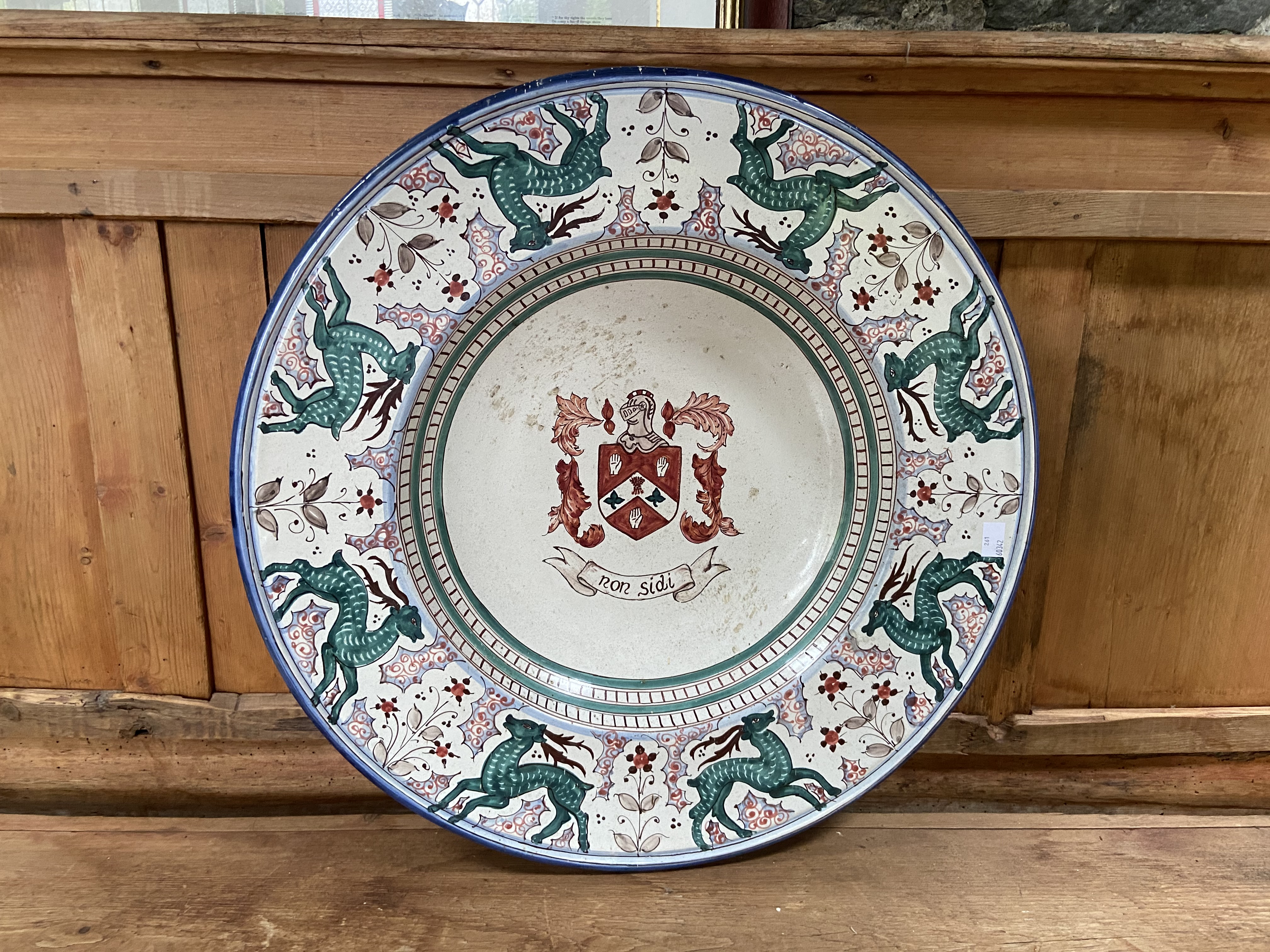 A large Continental glazed pottery Armorial Charger, the crest with the motto ''Non Sidi'' inside