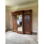 A fine Victorian mahogany breakfront Wardrobe, with moulded cornice above a centre mirror door and a