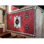 A red ground Afghan Rug, with ivory medallions and four smaller octagonal medallions inside a