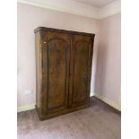 A Victorian figured walnut Wardrobe, with arched panel doors on plinth base, 81'' x 55'' (206cms x