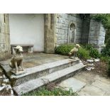 A pair of composition Garden Figures, each modelled as a life size seated hound, 27'' (69cms) h. (2)