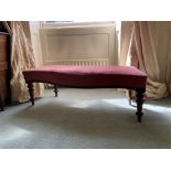 A Victorian serpentine fronted Window Stool, covered in pink fabric on four turned legs, 44'' (